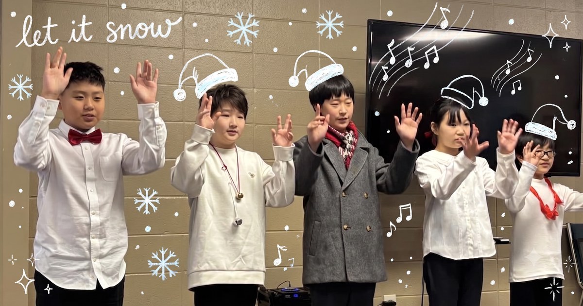 Children of the North Alabama Korean School choir singing together, with playful hand-drawn snow and Christmas doodles over the photo.